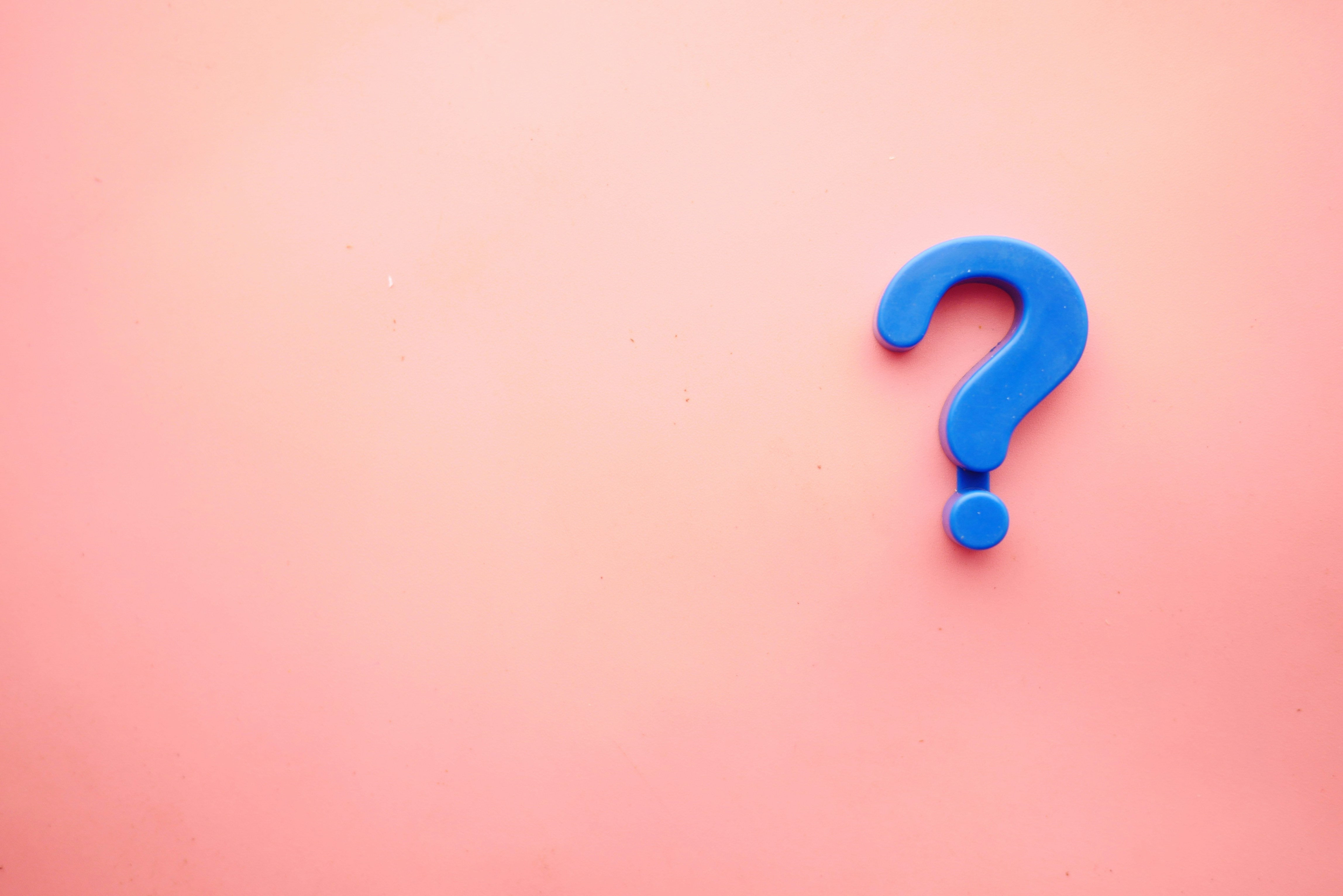 Blue question mark on pink gradient background